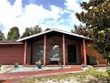 Charming single-story home featuring a brick facade, covered porch, and well-manicured landscaping at 14545 Sw 34Th Terrace Rd, Ocala, FL 34473