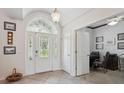 Bright foyer features a decorative leaded-glass door and sidelights that provide a warm welcome to the home at 8929 Sw 196Th Ct, Dunnellon, FL 34432