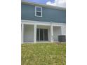 The backyard has sliding glass door entrance and lawn at 1129 Red Buckeye Ct, Deland, FL 32720