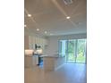 Modern, open kitchen features stainless steel appliances, granite countertops, and tile flooring at 1133 Red Buckeye Ct, Deland, FL 32720