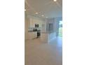 Open kitchen features granite countertops, stainless steel appliances, and tile flooring at 1145 Red Buckeye Ct, Deland, FL 32720