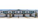 View of modern townhouse exteriors, showcasing consistent design elements and landscaping at 2465 Magnolia Reserve Rd, Ocoee, FL 34761
