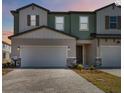 The townhome's exterior shows the paver driveway and walkway, and the attached garage at 2465 Magnolia Reserve Rd, Ocoee, FL 34761