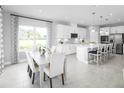 Bright kitchen with modern appliances, quartz countertops, and eat-in island open to the dining area at 1188 Ivy Manor St, Minneola, FL 34715