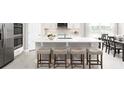 Modern kitchen featuring a central island with bar seating, stainless steel appliances, and a sleek design with hardwood floors at 1192 Ivy Manor St, Minneola, FL 34715