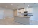 Modern kitchen with white cabinets, granite countertops, and stainless steel appliances at 572 Highfalls Ave, Debary, FL 32713