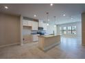 Bright kitchen featuring an island with granite countertops and stainless steel appliances at 572 Highfalls Ave, Debary, FL 32713