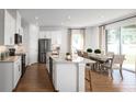 Open-concept kitchen with an island, stainless steel appliances, and a view to the backyard at 6501 Domizio Dr, Winter Haven, FL 33884