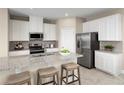 Bright kitchen features stainless steel appliances, granite countertops, and white cabinetry at 6505 Domizio Dr, Winter Haven, FL 33884