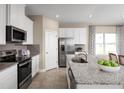 Modern kitchen with stainless steel appliances, granite countertops, and an island with seating at 6505 Domizio Dr, Winter Haven, FL 33884