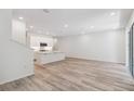 Bright open-concept living space with modern kitchen, wood-look flooring, and natural light at 5281 Luisa Ct, St Cloud, FL 34771