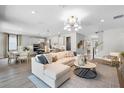 Bright living space with a comfortable sofa, modern decor, and an open layout seamlessly connecting to the kitchen at 823 Emerald Grove Dr, Apopka, FL 32703