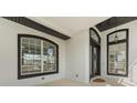 Inviting covered front porch with large windows and glass doors, offering natural light and a glimpse inside at 1148 Rosetta Dr, Deltona, FL 32725