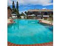 Large, refreshing community pool surrounded by lush greenery and lounge areas for residents to enjoy at 2200 S Palmetto Ave # E050, South Daytona, FL 32119
