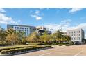 Modern office building with ample parking surrounded by lush landscaping, close to business amenities at 761 Mystic Gardens Dr, Apopka, FL 32703