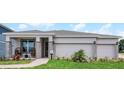Beautiful single-Gathering home with an attached two-car garage and landscaped yard at 636 Mystic Gardens Dr, Apopka, FL 32703