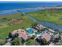 Aerial view of Bellalago community amenities including multiple pools, clubhouse, lake access, and lush green spaces at 3612 Northwoods Dr, Kissimmee, FL 34746