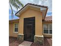 Close-up of the front entrance featuring a screened-in porch and stone accents at 3612 Northwoods Dr, Kissimmee, FL 34746