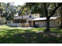 Exterior showcasing a two-story home, attached garage, and a screened porch at 5635 Kimball Rd, Mulberry, FL 33860