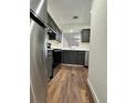 Efficient kitchen with stainless steel appliances and stylish gray cabinetry at 3006 S Semoran Blvd # 7, Orlando, FL 32822
