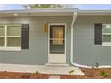 Front entrance with decorated front door, brick details and green shrubs at 3207 Cr 419, Lake Panasoffkee, FL 33538