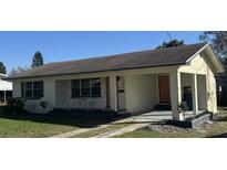 Charming single-story home with a well-maintained lawn and a cozy, covered front porch at 766 Bates Sw Ave, Winter Haven, FL 33880