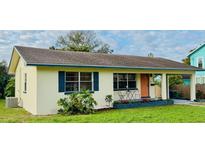 Charming single-story home with a well-manicured lawn and colorful accents and neutral exterior color at 766 Bates Sw Ave, Winter Haven, FL 33880