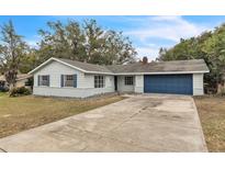 Newly renovated home with blue garage door and landscaped yard at 1228 Se 17Th St, Ocala, FL 34471