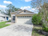 House exterior featuring a two-car garage and well-maintained lawn at 2907 Willow Oak Ct, Kissimmee, FL 34744