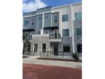 Modern 3-story townhome with gray and white exterior and balcony at 336 Center Lake Ln # A-2, Oviedo, FL 32765