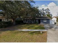 Charming single-story home with a well-maintained lawn, mature trees, and a classic design at 8115 Esperanza St, Orlando, FL 32817