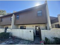 Two-story townhome with brown siding and a white stucco base at 1880 N Crystal Lake Dr # 57, Lakeland, FL 33801