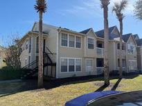 Tan two-story building with stairs and palm trees at 1049 S Hiawassee Rd # 3412, Orlando, FL 32835