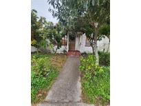 Small house with a walkway and overgrown yard at 4054 Columbia St, Orlando, FL 32811