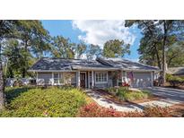 Charming single-story home with manicured landscaping, walkway, and American flag at 4503 Se 14Th St, Ocala, FL 34471