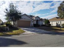 One-story house with a two-car garage and landscaped yard at 13026 Se 97Th Terrace Rd, Summerfield, FL 34491