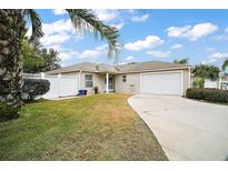 Charming single-story home featuring a well-manicured lawn and an attached two-car garage at 2378 Ridgeway Ct, The Villages, FL 32162