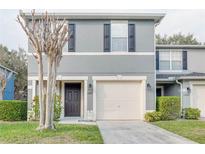 Charming two-story home with a well-maintained lawn and attached one car garage at 13071 Lexington Summit St, Orlando, FL 32828