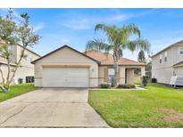 Charming single-story home featuring a well-maintained front yard and attached two-car garage at 358 Canna Dr, Davenport, FL 33897