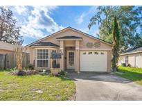 Charming single-story home with a well-manicured lawn and a one-car garage at 428 Winding Oak Ln, Longwood, FL 32750