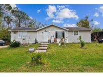 Charming single-story home featuring a well-maintained lawn and cozy front porch at 2486 Daytona Park Rd, Deland, FL 32724
