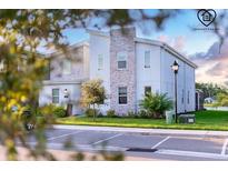 Modern two-story home with stone accents, green landscaping, and a well-maintained lawn at 2855 Bookmark Dr, Kissimmee, FL 34746