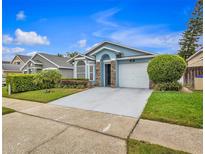 Charming single-story home featuring stone accents, manicured landscaping, and an attached two-car garage at 203 Horstfield Dr, Winter Garden, FL 34787