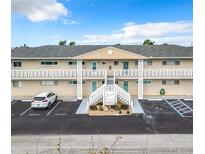 Condominium building featuring well maintained landscaping, multiple guest parking spots, and stairwell access at 335 N Causeway # E3, New Smyrna Beach, FL 32169