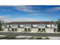 New townhome exterior featuring a two-story building with individual garages, covered entries, and modern color palettes at 2549 Penguin Blvd, Davenport, FL 33837