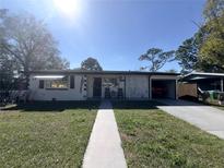 Charming single-story home with well-maintained front yard and inviting walkway leading to the entrance at 574 E Normandy Blvd, Deltona, FL 32725