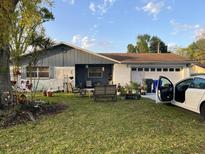 Charming single-story home with front yard and outdoor seating at 1920 Kimball S Ct, Lakeland, FL 33813