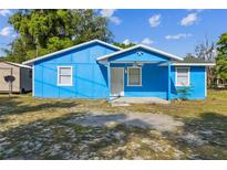 Bright blue single story home with white trim and covered entry at 1720 S Warnell Rd, Coleman, FL 33521