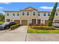 Inviting townhome exterior featuring a well-manicured lawn and convenient driveway at 3747 Woodbury Hill Loop, Lakeland, FL 33810