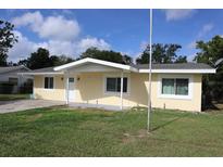 Charming single-story home with a well-manicured lawn and welcoming front porch at 124 Auburn Rd, Auburndale, FL 33823